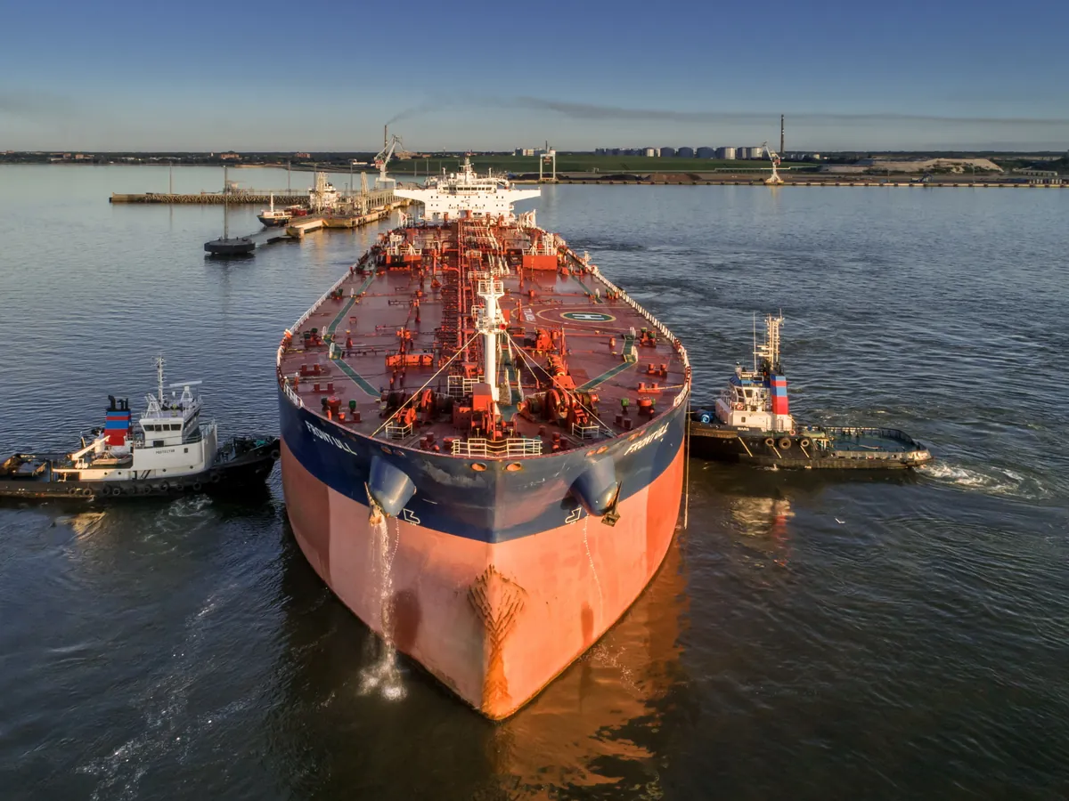 A tanker berthing with two tugs at Sillamäe port in Estonia, a Baltic terminal on the chemical supply corridors