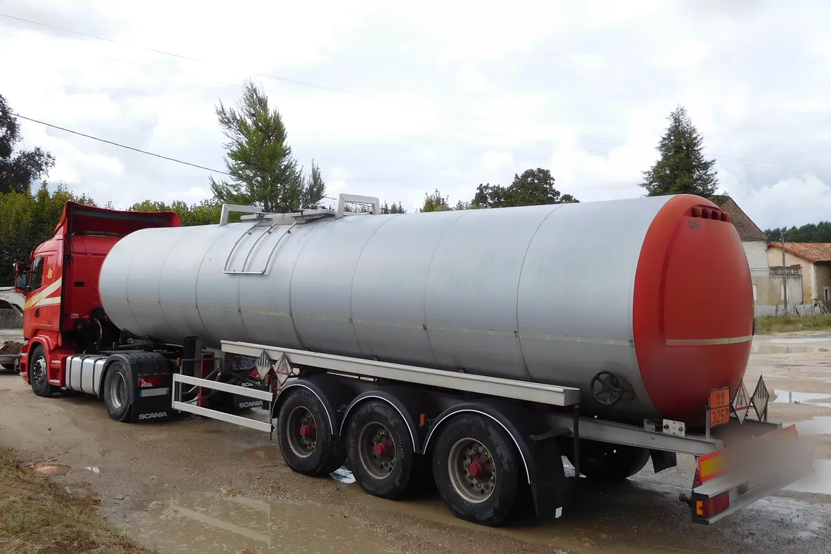 Insulated bitumen tank semi-trailer behind a Scania tractor, the heated tank bitumen travels in