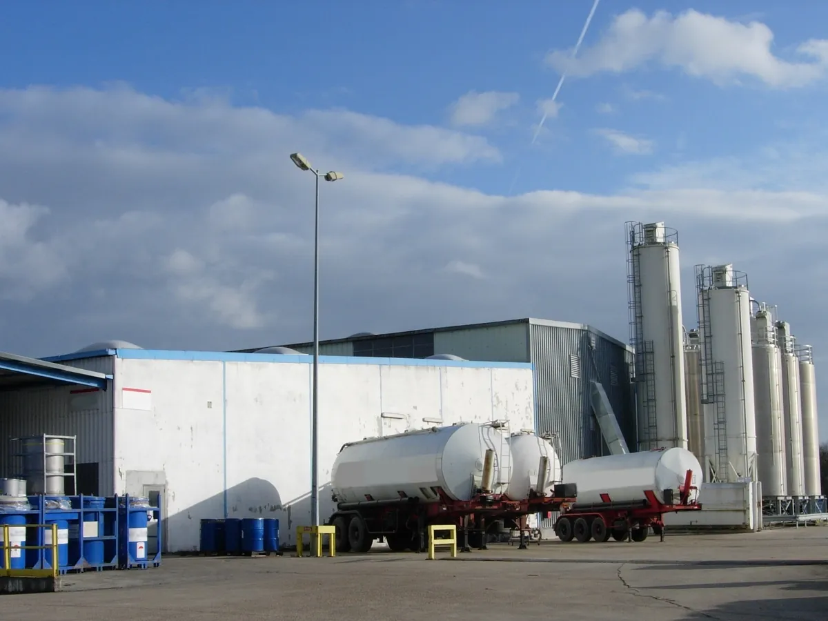 Tank semi-trailers at a parachemical plant in France, beside drums, IBCs and storage silos