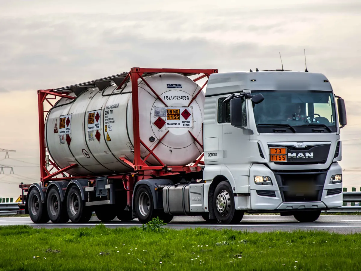 ISO tank container with UN 1155 placards on a container chassis, on the A17 near Moerdijk