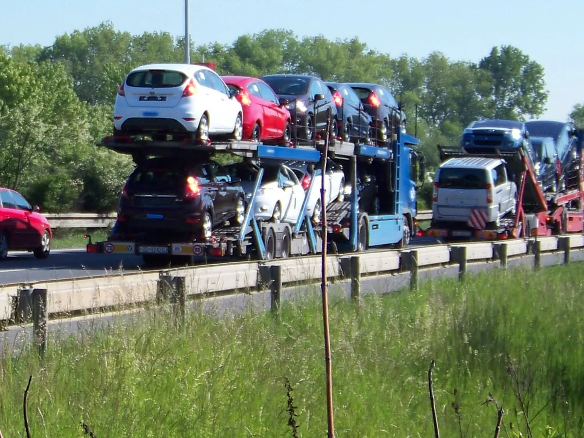 Two loaded car transporters in traffic on a Central European motorway