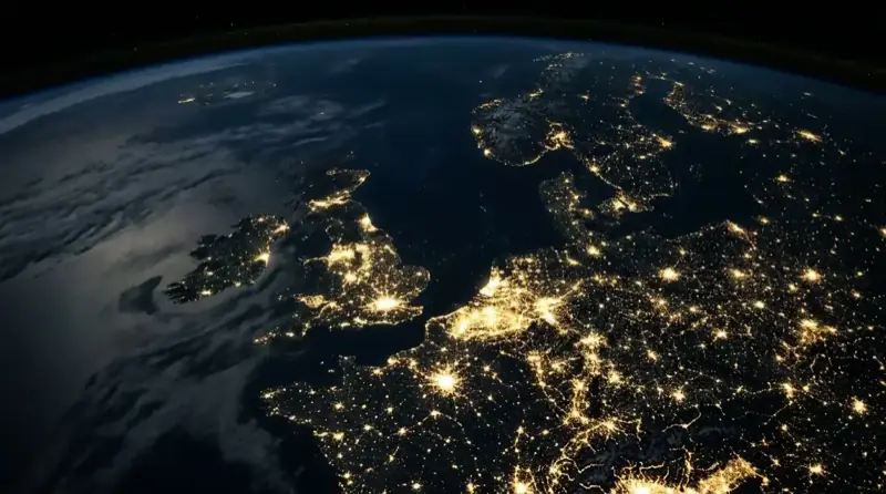 Europe at night seen from orbit, its cities lit along the freight corridors